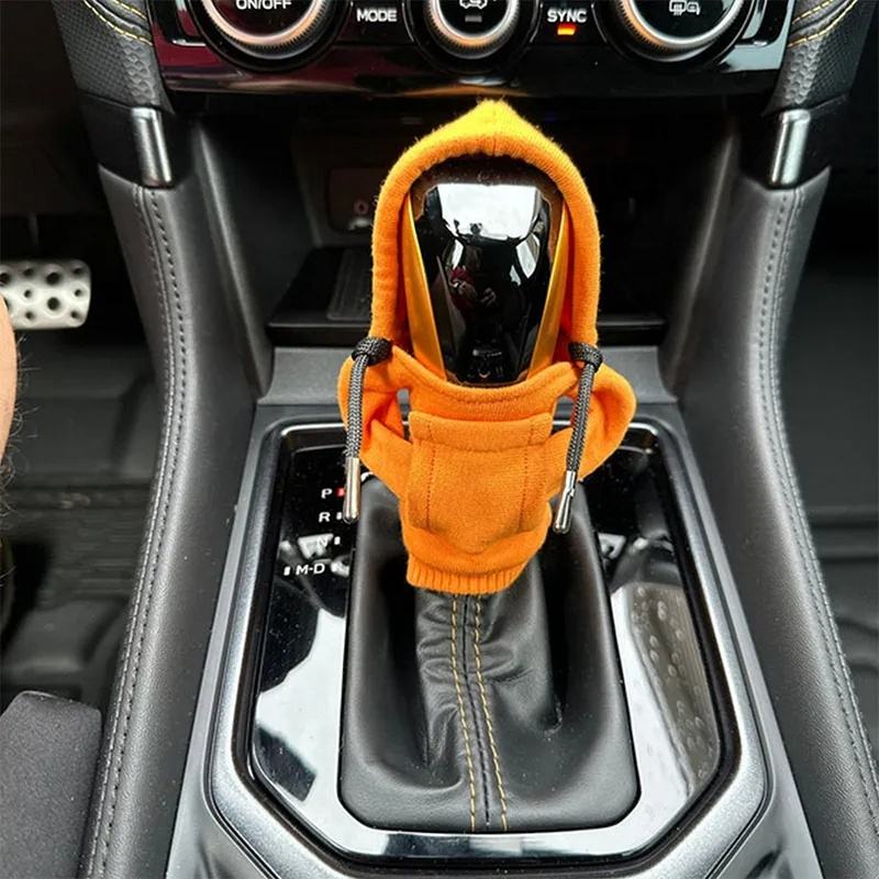 Orange mini hoodie on car gear lever