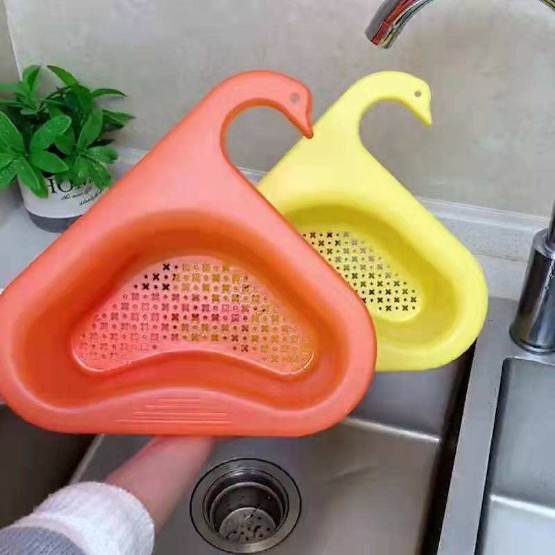 Yellow and orange triangular drain baskets beside a kitchen sink